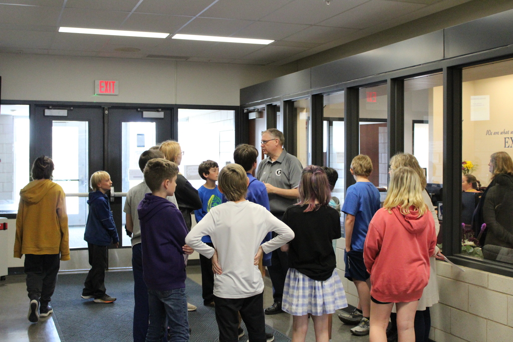 Incoming 6th graders being talked to by Mr. Thofson outside the Secondary Office.