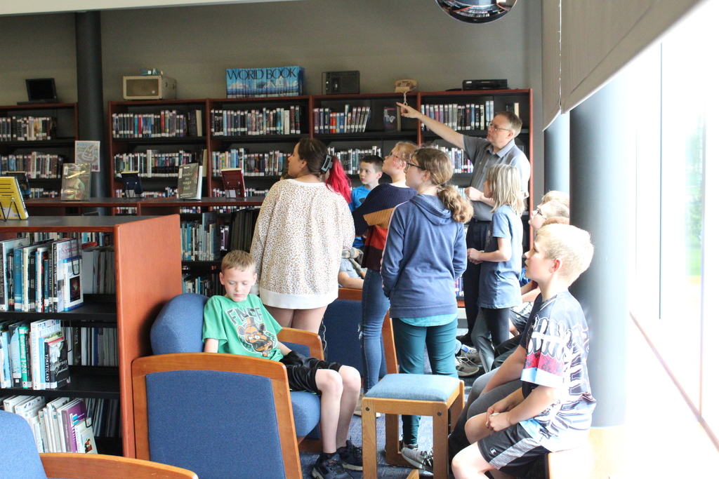 Incoming 6th graders being shown the third floor from in the Secondary Media Center.
