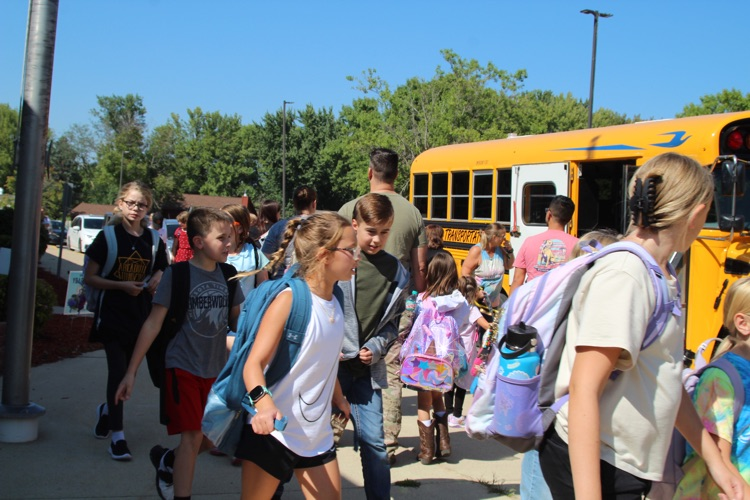 elementary dismissal. kids walking to buses